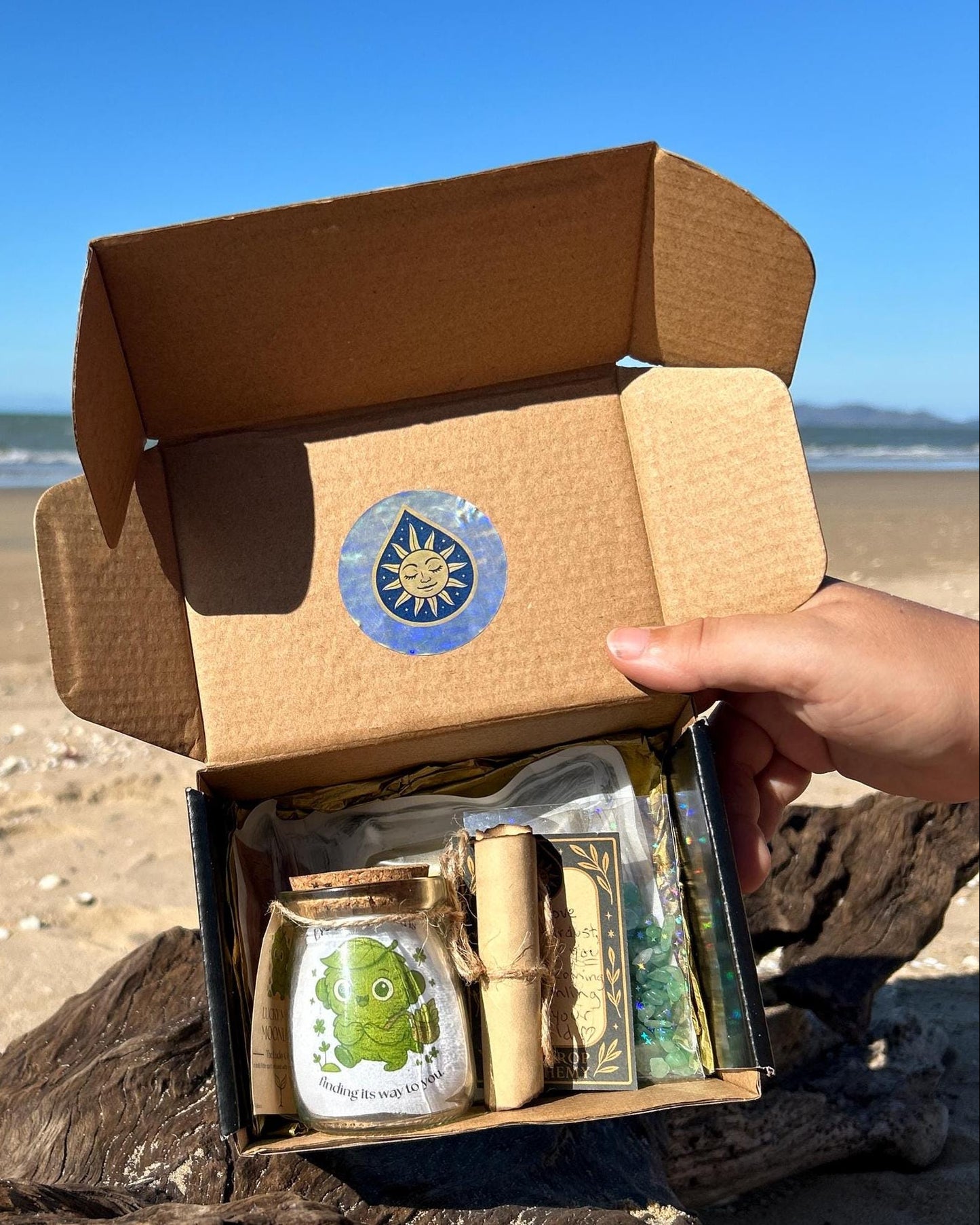 Open cardboard box with mooonling contents on a beach