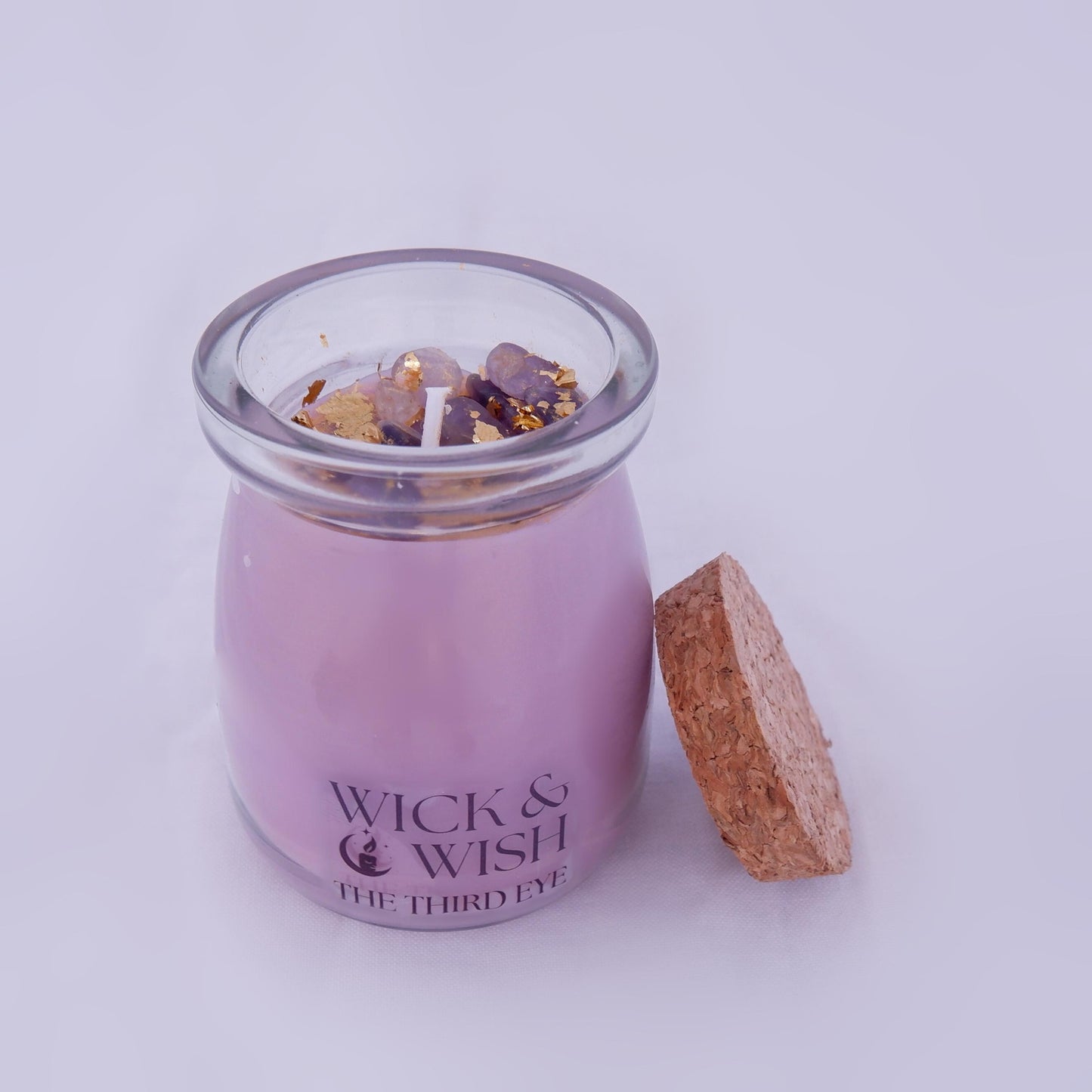 The Third Eye candle in a glass jar with a cork lid on a white background, branded 'Wick & Wish'.