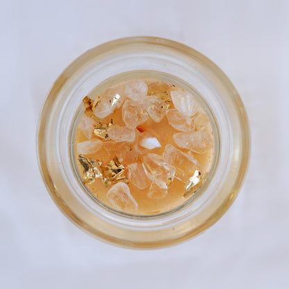Small glass container with gold and clear decorative elements on a white background